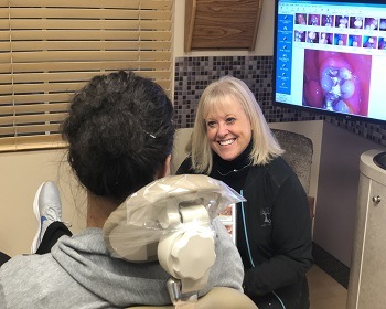 Dentist smiling at dental patient