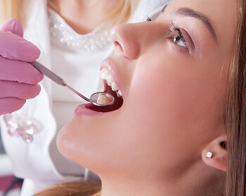 Dentist performing dental exam