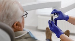 Dentist in Powell reviewing dental implant treatment process with patient