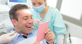 Patient in Powell smiling after receiving dental implant restoration