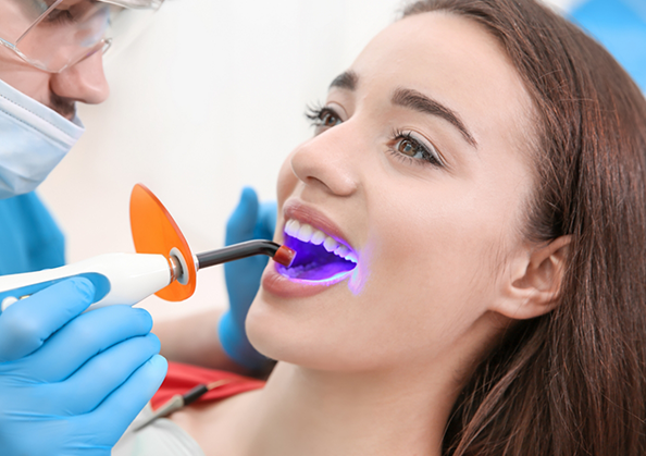 Young woman getting dental bonding