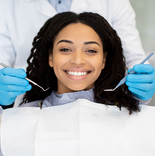 Woman grinning during a dental checkup in Powell