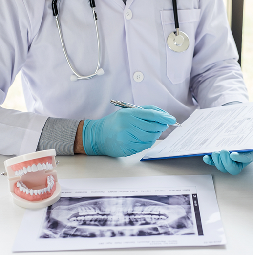 Dentist near Columbus looking at charts and x rays for a patient