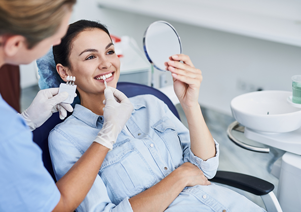 Dentist fitting a patient with veneers