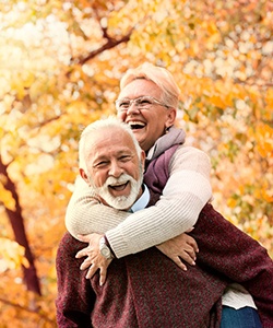 An older couple enjoying time spent outside during the fall after receiving dentures in Powell
