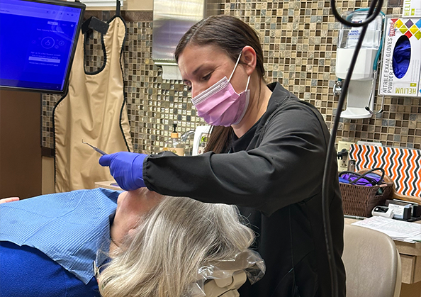 Dental hygienist giving a patient a teeth cleaning