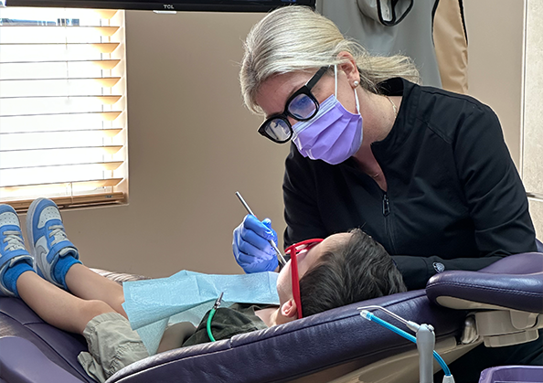 Dentist giving a child a dental exam