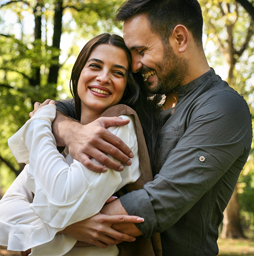 Man and woman embracing outdoors after cosmetic dentistry in Powell