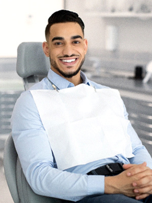 Patient smiling while sitting in treatment chair