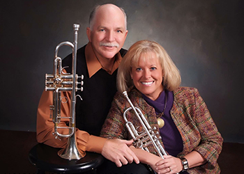 Dr. Shults and her husband with trumpets