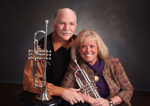 Doctor Shults and her husband with two silver trumpets