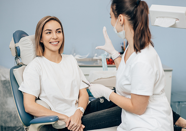 Woman in the dental chair listening to her dentist
