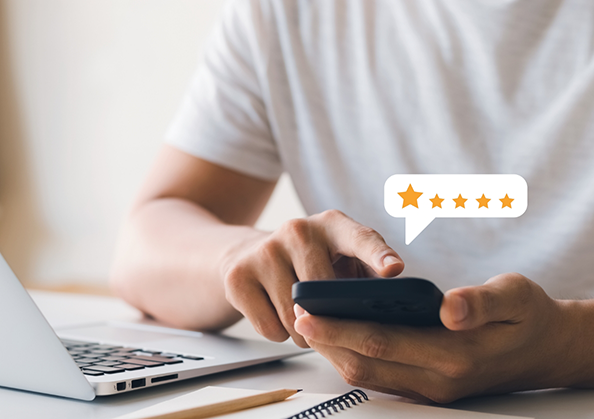Person leaving a five star review on their phone